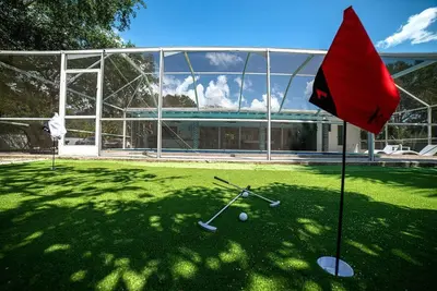 a red flag in front of a building with a golf ball at Luxury Miami Village w/Pool+Grill+MiniGolf in Miami