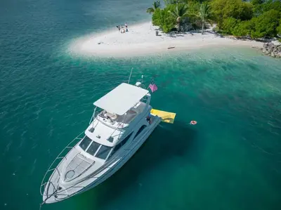 a boat in the water next to a beach at Luxury Miami Village w/Pool+Grill+MiniGolf in Miami