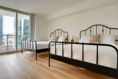 a bedroom with two beds and a large window at One of Brickell Bays Best with Pool and Gym Access in Miami