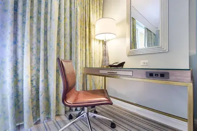 a room with a desk with a chair and a mirror at Stunning Studio Apartment Located at the Ritz Carlton-Key Biscayne in Miami
