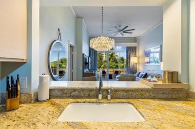 a kitchen with a sink and a living room at Breathtaking 2 Bedroom Condo Placed at Ritz Carlton-Key Biscayne in Miami