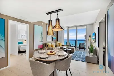 a living room and dining room with a table and chairs at Brand New 2Br Insane Ocean View and Amenities in Hollywood