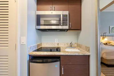 a small kitchen with a sink and a microwave at Charming 5 Star Condo Unit Situated at Ritz Carlton-Key Biscayne in Miami