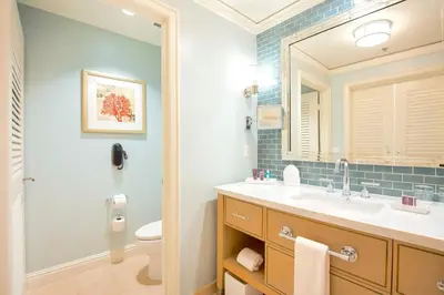a bathroom with a sink and a mirror and a toilet at Charming 5 Star Condo Unit Situated at Ritz Carlton-Key Biscayne in Miami