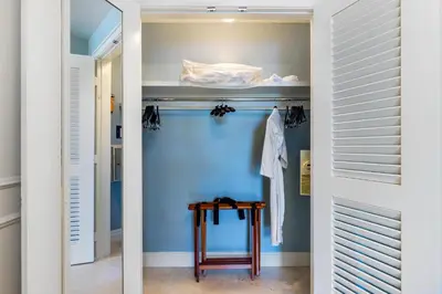 a walk in closet with blue walls and a wooden table at Lovely Deluxe Unit Located at Ritz Carlton - Key Biscayne! in Miami