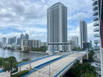 a city with a bridge over a river and buildings at Refined Oceanview Apartment, Kitchen, Comfort & Location -A in Hallandale Beach