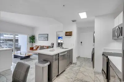 a kitchen and living room with a couch at Subtle 2 Bed in Edgewater near Downtown With Free Parking in Miami