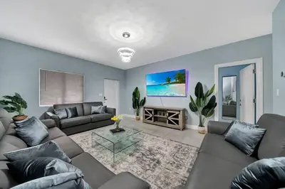 a living room with a couch and a table at Luxury Duplex in Heart of Fort Lauderdale Near The Beach in Fort Lauderdale