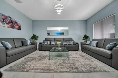 a living room with two couches and a glass table at Luxury Duplex in Heart of Fort Lauderdale Near The Beach in Fort Lauderdale