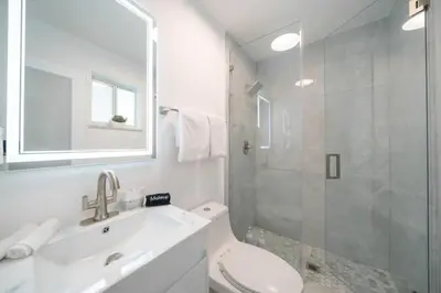 a bathroom with a toilet and a sink and a shower at Luxury 7BR Villa Vizcaya Pool Sauna Gym Golf in Miami