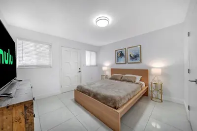 a bedroom with a bed and a flat screen tv at Luxury 7BR Villa Vizcaya Pool Sauna Gym Golf in Miami