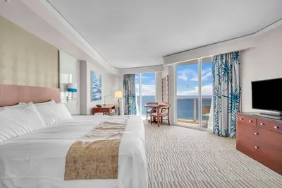 a hotel room with a large bed and a television at TRUMP INTERNATIONAL BEACH RESORT 2 BEDROOM APARTMENT 1600 Sqf OCEAN FRONT in Miami Beach