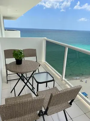 a balcony with a table and chairs and the ocean at Penthouse Beach Front 1st line, 2 BR, 2 BA, New Decoration & Furnitures, unobstructed view of the beautiful Atlantic, free parking in Hollywood
