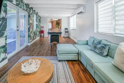 a living room with a couch and a table at La Playita 4-BR Heated Pool Miami 16 Guests in Miami