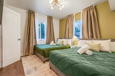 a bedroom with two green beds and a window at La Playita 4-BR Heated Pool Miami 16 Guests in Miami
