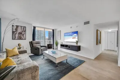 a living room with a couch and a tv at 37th floor Amazing spacious unit with parking in Miami
