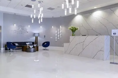a lobby with a reception desk and blue chairs at 37th floor Amazing spacious unit with parking in Miami