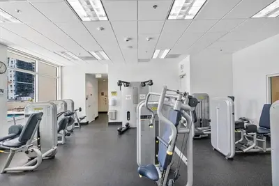 a gym with rows of cardio equipment in a room at 37th floor Amazing spacious unit with parking in Miami