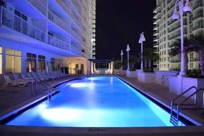 a swimming pool in the middle of a building at night at Ocean front private unit in Miami
