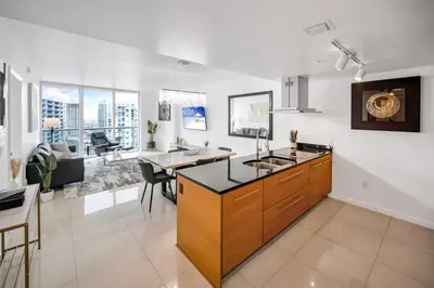 a kitchen with a sink and a living room at 38th floor W residence with amenities in Miami