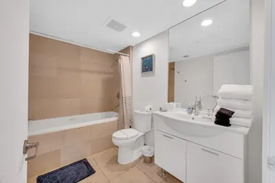 a bathroom with a toilet and a sink and a tub at Highest floor Icon W Brickell Location in Miami