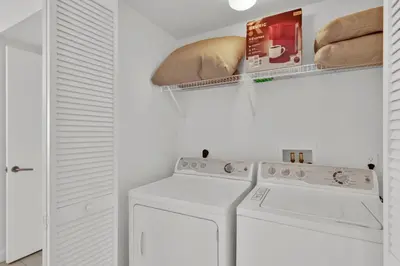 a laundry room with a washer and dryer at Water View Building With Pool - 5-Min Walk To The Beach in Hallandale Beach