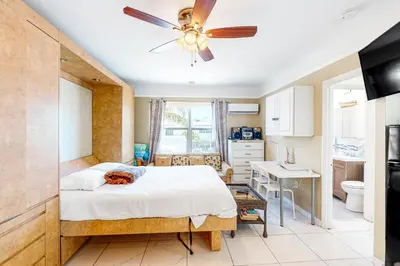 a bedroom with a bed and a ceiling fan at Eternal Coastal Sunshine in Hollywood