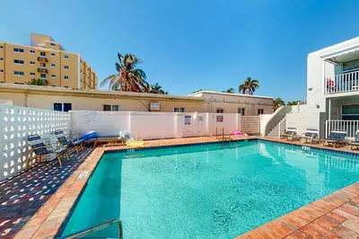 a swimming pool with chairs and a building at Eternal Coastal Sunshine in Hollywood