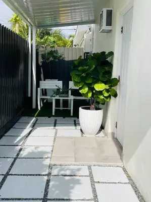 a plant in a white vase on a patio at Alma Guest Suite in Miami