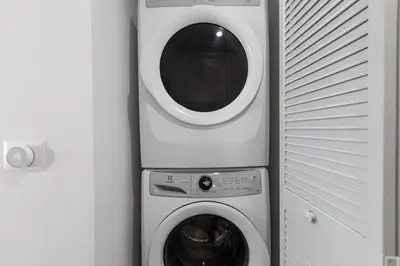 a washing machine and a dryer next to a wall at Corner condo w/ Unrivaled views in Miami