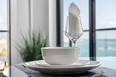 a cup and a wine glass on a table at Corner condo w/ Unrivaled views in Miami