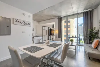 a dining room with a white table and chairs at Cozy Downtown Pad- Luxe Rooftop pool gym and more in Miami