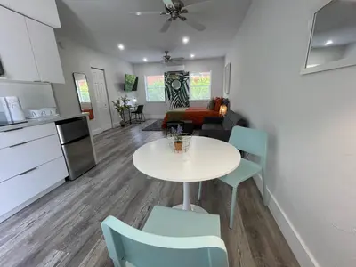 a kitchen and a living room with a table and chairs at Casa Habana Studios in Miami