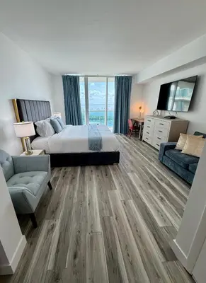 a bedroom with a bed and a tv and a couch at Balcony Ocean View ! WiFi - Pool - Gym - Parking in Miami