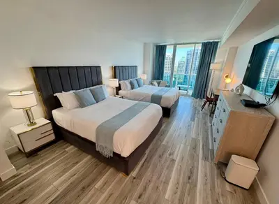 a hotel room with two beds and a large window at Balcony Ocean View ! WiFi - Pool - Gym - Parking in Miami