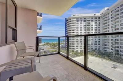 a balcony with chairs and a view of the ocean at Luxury Beachfront Ocean View Beach Access-817 in Miami Beach