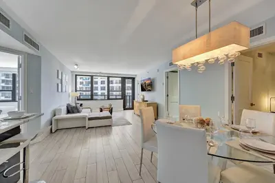 a living room with a table and a dining room at Luxury Beachfront Ocean View Beach Access-817 in Miami Beach