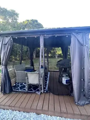 a gazebo with chairs and a grill on a deck at Modern Tropical Oasis with Arcade, HotTub & MiniGolf in Hollywood