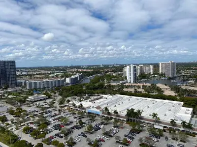 an aerial view of a parking lot in a city at Your BeachWalk Retreat, Spacious Studio, Family-Friendly in Hallandale Beach