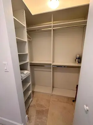 a walk in closet with white closets at Oceanview Luxury 2BR with Pool & Beach in Hallandale Beach