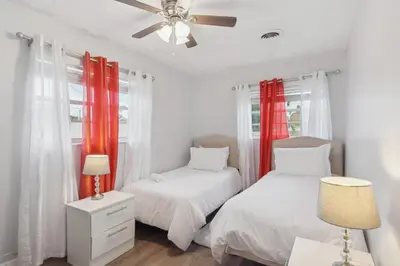 a bedroom with two beds and a ceiling fan at Patio and Yard Family-Friendly Miami Oasis! in Miami Gardens