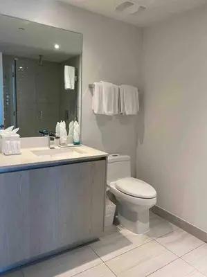 a bathroom with a toilet and a sink and a mirror at Luxury 2 bedroom with ocean view in Hollywood