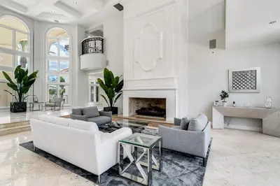 a living room with two couches and a fireplace at Incredible 9 Bedroom 11 Bath Idlewyld Mansion in Fort Lauderdale
