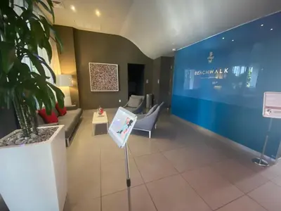a waiting room with a couch and a chair at Modern Studio Escape at BeachWalk, Perfect for Small Groups -B in Hallandale Beach