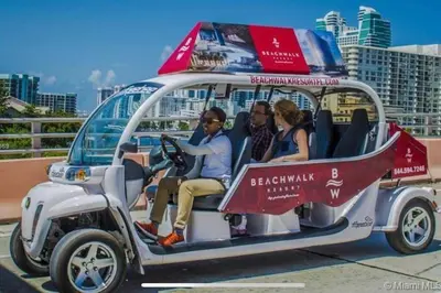 a group of people sitting in a golf cart at Sophisticated Beach Escape, Breathtaking Views & Comfort -2A in Hallandale Beach