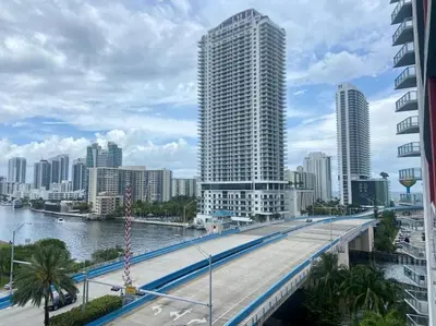 a bridge over a river in a city with tall buildings at Cozy Beach Apartment with Full Kitchen -A in Hallandale Beach