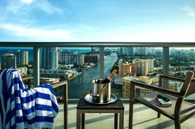 a room with a balcony with a view of a city at Cozy Beach Apartment with Full Kitchen -A in Hallandale Beach