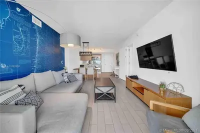 a living room with a couch and a tv at Relax in Style, Miami Beach Apt with Full Kitchen and Dreamy Views -A in Hallandale Beach