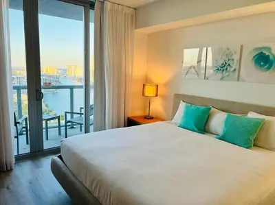 a bedroom with a large bed and a large window at Seaside Retreat in Miami, Full Kitchen & Balcony Views -A in Hallandale Beach