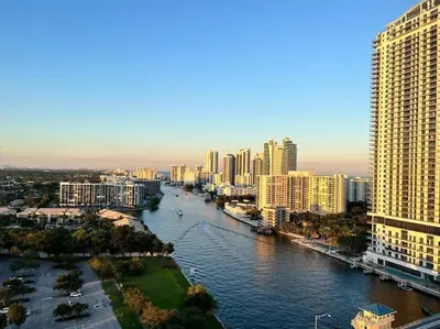 a view of a city with a river and buildings at Seaside Retreat in Miami, Full Kitchen & Balcony Views -A in Hallandale Beach